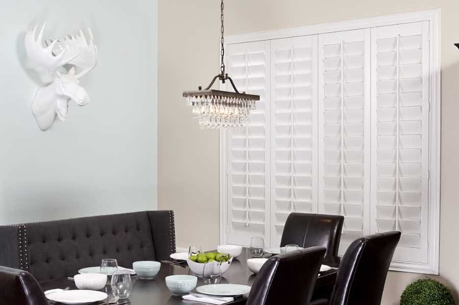 Get the best insulation from your shutters when you buy them from the pros. Closed Polywood shutters on a dining room window